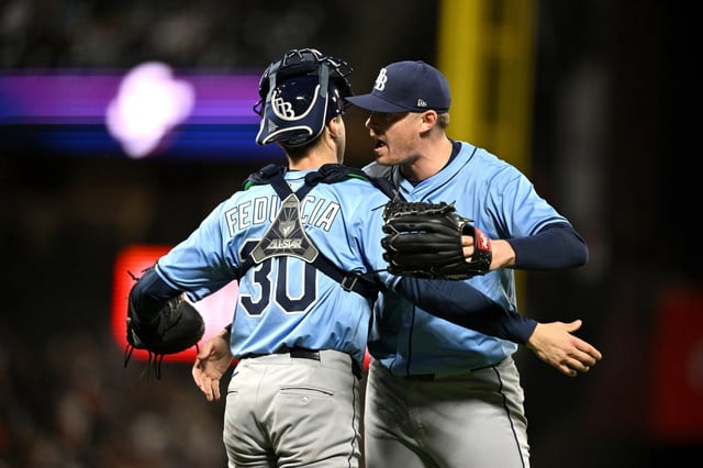 The Rays&#39; Pete Fairbanks (29) celebrates with Hunter Feduccia after their victory Saturday night in San Francisco.  (Photo by Brandon Vallance/Getty Images)