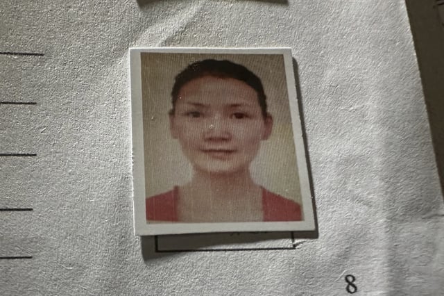 A picture of Chinese climber Guan Jing, who was killed on K2, the world's second-highest peak, is seen on a document, which shown by Shahbaz Khan, station manager of a Pakistani tour operator "Imagine Club Pakistan" at his office in Skardu, in northern Pakistan, Saturday, Aug. 16, 2025. (AP Photo/M.H. Balti)