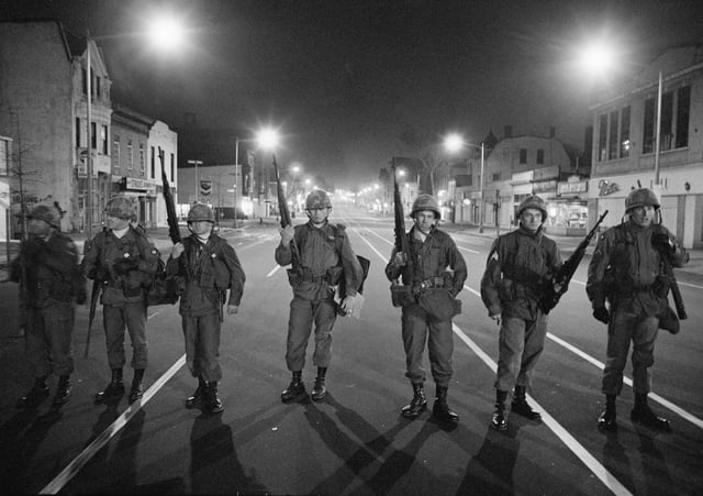 Troops patrol a downtown street in Washington, DC, after President Johnson ordered them in to help police on April 5, 1968.