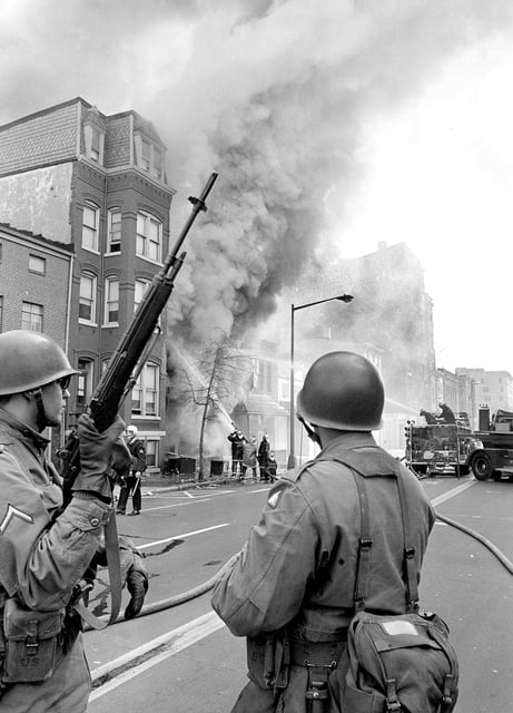 National Guard troopers stand guard on 9th Street between L and M Streets in the northwest section of Washington, D.C., April 6, 1968. The nation's capital has been rocked by rioting in the wake of the assassination of Dr. Martin Luther King Jr. on April 4 in Memphis. (AP Photo/Bob Schutz)