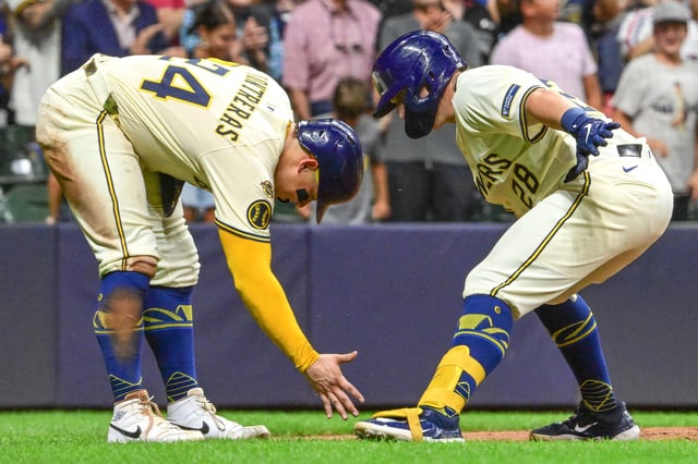 Brewers first baseman Andrew Vaughn celebrates with catcher William Contreras after hitting a home run against the Pirates.