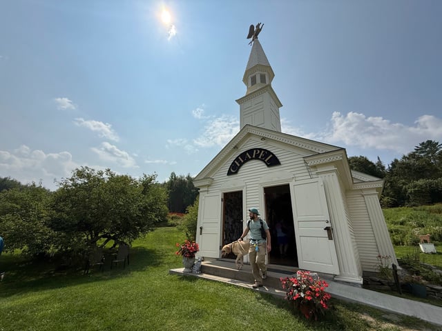 Billy Curtin and his dog, Brewster, leave the Dog Chapel at Dog Mountain, a 150-acre dog park created by Vermont folk artist Stephen Huneck, Thursday, Aug. 7, 2025, in St. Johnsbury, Vt. (AP Photo/Amanda Swinhart)