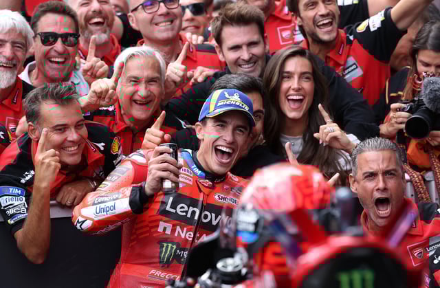 MotoGP - Austrian Grand Prix - Red Bull Ring, Spielberg, Austria - August 17, 2025 Ducati Lenovo Team's Marc Marquez celebrates with his team after winning the Austrian MotoGP REUTERS/Gintare Karpaviciute