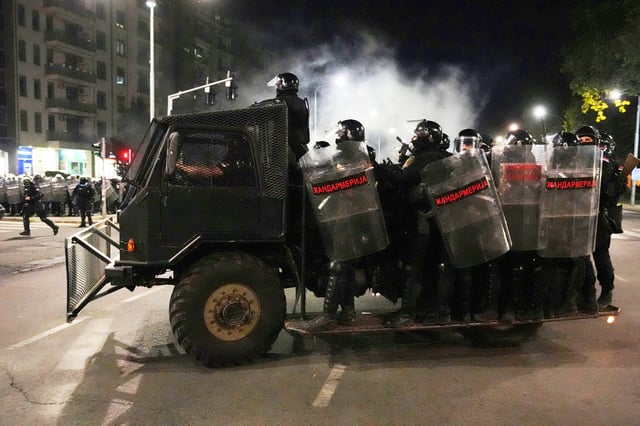 Serbian gendarmerie officers patrol in truck after clearing people blocking a street during an anti-government protest in Belgrade, Serbia, Saturday, Aug. 16, 2025. (AP Photo/Darko Vojinovic)
