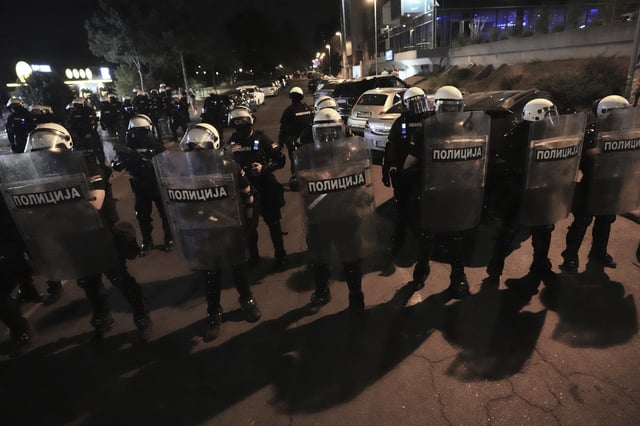 Serbian riot police officers guard an intersection after clearing people blocking a street during an anti-government protest in Belgrade, Serbia, Saturday, Aug. 16, 2025. (AP Photo/Darko Vojinovic)
