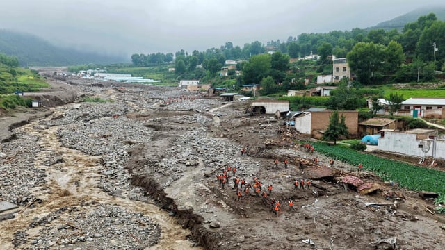 Rescue workers search for survivors after a flash flood in Yuzhong county, in China�s northwest Gansu province on August 8, 2025.
