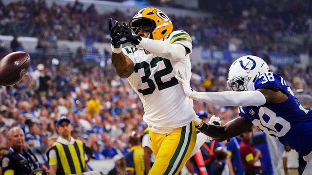 Green Bay Packers running back MarShawn Lloyd (32) and Indianapolis Colts cornerback Chris Lammons (38) miss a long pass on Saturday, Aug. 16, 2025, during a game against the Green Bay Packers at Lucas Oil Stadium in Indianapolis.