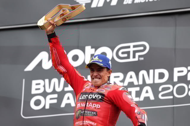 MotoGP - Austrian Grand Prix - Red Bull Ring, Spielberg, Austria - August 17, 2025 Ducati Lenovo Team's Marc Marquez celebrates with a trophy on the podium after winning the Austrian MotoGP REUTERS/Gintare Karpaviciute