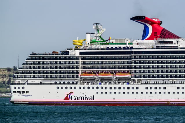 Carnival Miracle, a 88,500 GT Spirit-class cruise ship operated by Carnival Cruise Line, sails the Tagus River after departure from the cruise terminal, in Lisbon, Portugal, on June 3, 2025.