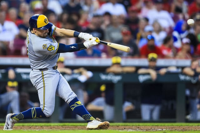 Milwaukee Brewers third baseman Caleb Durbin hits a double in the seventh inning against the Cincinnati Reds on Saturday.