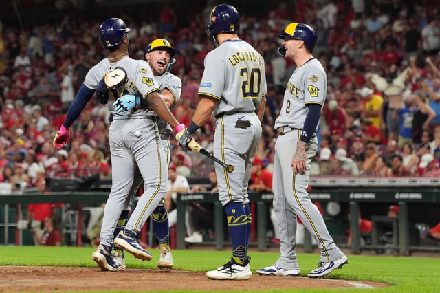 Caleb Durbin #21 of the Milwaukee Brewers celebrate 3 run home with Brice Turang #2 , Brandon Lockridge #20 and Andruw Monasterio #14 of the Milwaukee Brewers during the eleventh inning against the Cincinnati Reds at Great American Ball Park on August 16, 2025 in Cincinnati, Ohio.
