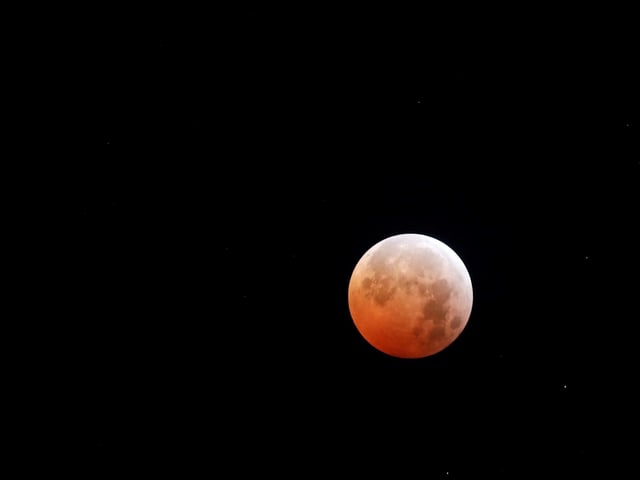 The moon is seen during a total lunar eclipse in San Salvador, El Salvador, March 14, 2025. REUTERS/Jose Cabezas