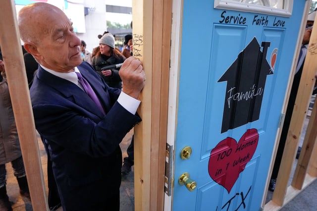 Mayor John Whitmire signs a wall that honors President Jimmy Carter during a memorial event at the Barbara Bush Literary Plaza on Tuesday, Jan. 7, 2025 in Houston. The City of Houston and Houston Habitat for Humanity joined together symbolically raised a wall that citizens were encouraged to sign, honoring the countless contributions President Jimmy Carter has made to the organization and to Habitat homeowners for nearly four decades.