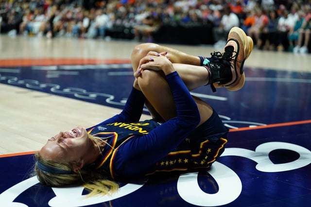 Aug 17, 2025; Uncasville, Connecticut, USA; Indiana Fever guard Sophie Cunningham (8) on the court injured as they take on the Connecticut Sun in the first half at Mohegan Sun Arena. Mandatory Credit: David Butler II-Imagn Images