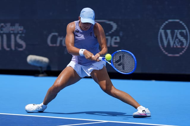 Aug 17, 2025; Cincinnati, OH, USA;  Iga Swiatek (POL) returns a shot against Elena Rybakina (KAZ) during the Cincinnati Open at the Lindner Family Tennis Center. Mandatory Credit: Aaron Doster-Imagn Images