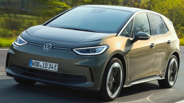 volkswagen id3 driving down a street