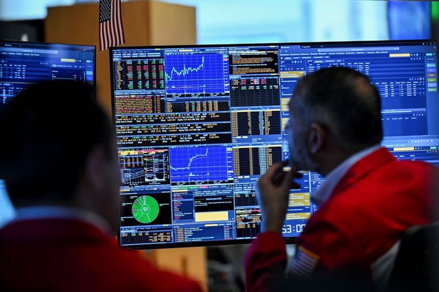 Traders work on the floor of the New York Stock Exchange on Wednesday.