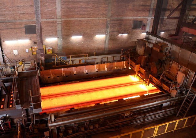 Slabs of steel are cut by machine at the BlueScope steelworks, Port Kembla, Australia February 9, 2024. REUTERS/Lewis Jackson/File Photo