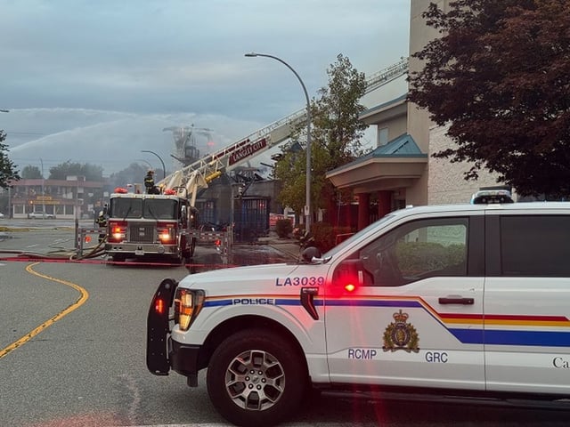 Firefighters are seen during fire suppression at a building in Langley, B.C., in a handout photo. THE CANADIAN PRESS/Handout — RCMP (Mandatory Credit)