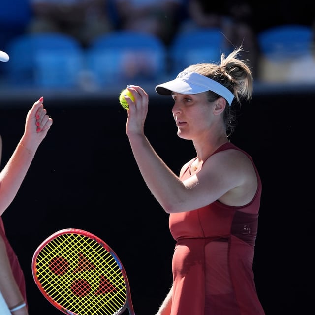 Canada's Gabriela Dabrowski, right, reacts with partner Erin Routliffe of New Zealand during their women's doubles semifinal against Hsieh Su-Wei of Taiwan and Jelena Ostapenko of Latvia at the Australian Open tennis championship in Melbourne, Australia, Friday, Jan. 24, 2025. (AP Photo/Ng Han Guan)