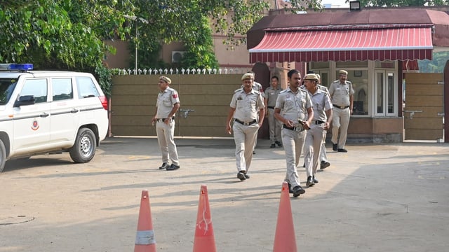 File photo of police conducting searches at a Delhi school that received a bomb threat.