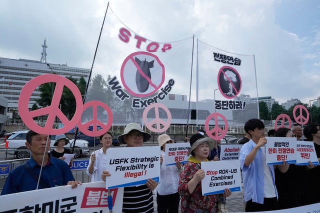 South Korean protesters stage a rally to oppose the joint military exercises, Ulchi Freedom Shield or UFS, between the U.S. and South Korea in front of the presidential office in Seoul, South Korea, Monday, Aug. 18, 2025. The banners read "Stop the military exercise between the U.S. and South Korea." (AP Photo/Ahn Young-joon)