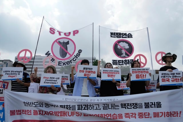 South Korean protesters stage a rally to oppose the joint military exercises, Ulchi Freedom Shield or UFS, between the U.S. and South Korea in front of the presidential office in Seoul, South Korea, Monday, Aug. 18, 2025. The banners read "Stop the military exercise between the U.S. and South Korea." (AP Photo/Ahn Young-joon)