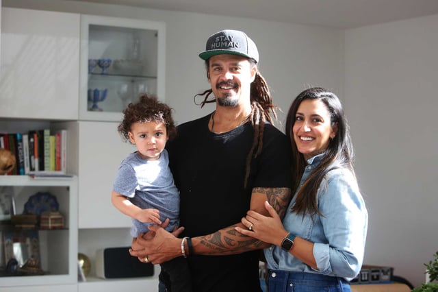 Michael Franti (center) and Sara Agah Franti (right) stand for a portrait with their son at their home on February 10, 2020 in San Francisco.
