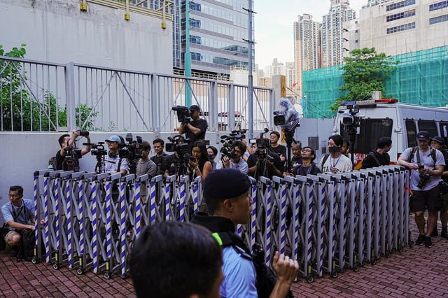 Members of media wait outside the West Kowloon Magistrates' Courts building for the closing submissions in the national security collusion trial of Jimmy Lai, founder of the now-defunct pro-democracy newspaper Apple Daily, in Hong Kong, China, August 15, 2025. REUTERS/Lam Yik