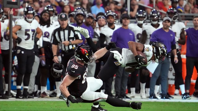 Aug 21, 2022; Glendale, Arizona, USA; Baltimore Ravens cornerback Kyle Fuller (18) intercepts a pass intended for Arizona Cardinals wide receiver Andre Baccellia (82) during the first half at State Farm Stadium. Mandatory Credit: Joe Camporeale-Imagn Images