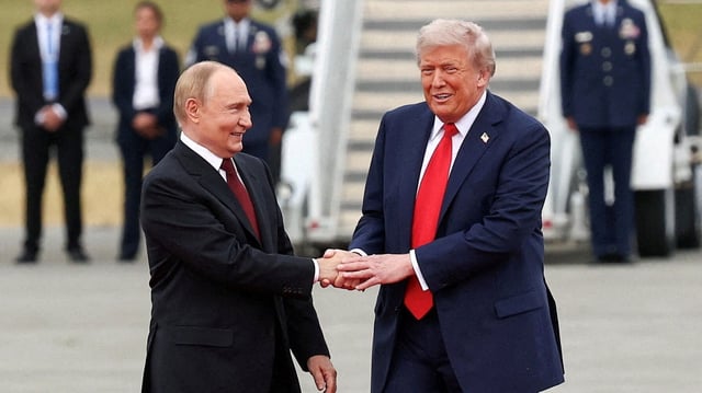 US President Donald Trump shakes hand with Russian President Vladimir Putin