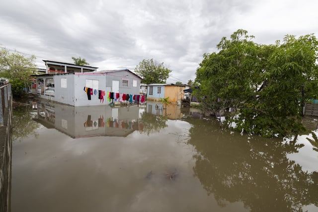 Water surrounds a house in Guayama, Puerto Rico, as Hurricane Erin brings rains to the island, Sunday, Aug. 17, 2025. (AP Photo/Alejandro Granadillo)