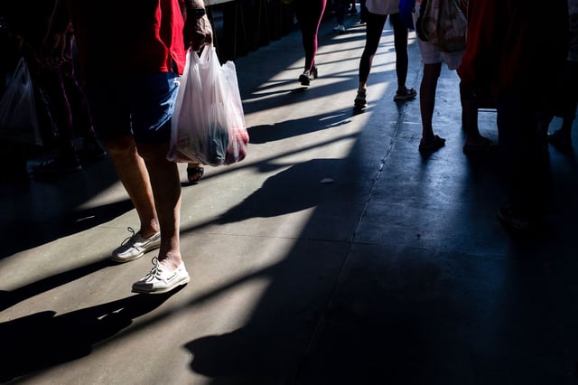 A shopper carries a bag at Eastern Market in Detroit, Michigan on Saturday, June 7.