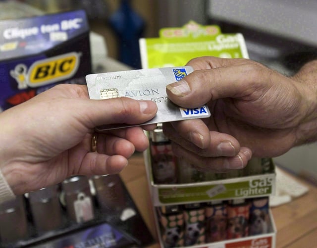 About 1.4 million Canadians missed a credit card payment in the second quarter, up by 118,000 missed payments from a year ago, an Equifax report said. A consumer pays with a credit card at a store in Montreal on July 6, 2010. THE CANADIAN PRESS/Ryan Remiorz