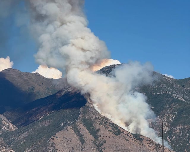 Thick smoke rises from the wildfire raging across the mountain in the Provo area of Utah.