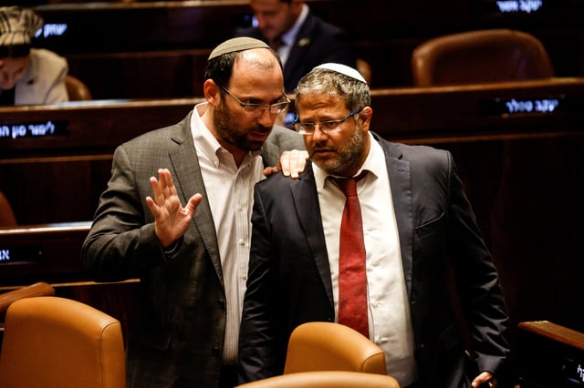 Israeli National Security Minister Itamar Ben-Gvir and Head of the Knesset Constitution, Law and Justice Committee Simcha Rothman speak as lawmakers gather at the Knesset plenum to vote on a bill that would limit some Supreme Court power, in Jerusalem July 24, 2023. REUTERS/Amir Cohen/File Photo