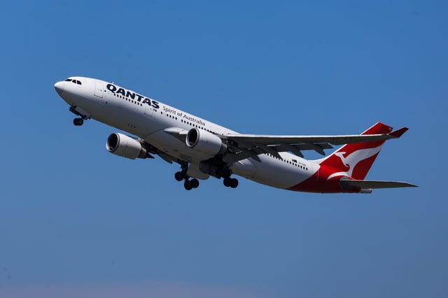 SYDNEY, AUSTRALIA - FEBRUARY 22: A Qantas plane takes off from Sydney International Airport on February 22, 2024 in Sydney, Australia. Qantas has demonstrated a significant financial turnaround, reporting a record $2.47 billion profit for the 2022-23 fiscal year, marking a stark change from the previous year's $1.86 billion loss. The airline's strong performance was attributed to robust travel demand and high ticket prices, with domestic earnings before interest and taxes (EBIT) jumping to 18.2%, representing a 50% increase in profit margins over the past six years. The company's return on invested capital also increased to 103.6%, reflecting its improved financial position and operational performance. (Photo by Jenny Evans/Getty Images)