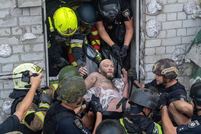 Rescatistas evacúan a un civil herido tras el impacto de un ataque de misiles rusos contra un edificio residencial en Járkiv, Ucrania, el lunes 18 de agosto de 2025. (AP Foto/Andrii Marienko)