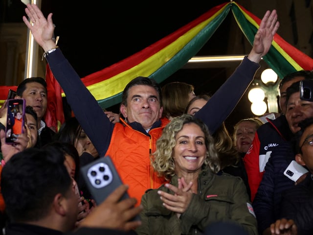 Bolivian presidential candidate centrist Senator Rodrigo Paz of the Christian Democratic Party (PDC), accompanied by his wife Maria Elena Urquidi, reacts, as early official results show that he is leading Sunday's presidential race, in La Paz, Bolivia August 17, 2025. REUTERS/Pilar Olivares