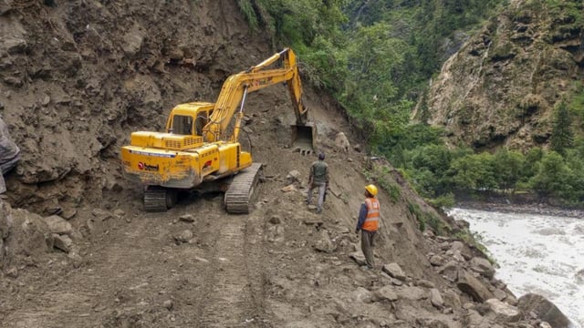 Work underway to repair a damaged portion of Gangotri National Highway, in Uttarkashi district, on Monday. (PTI)