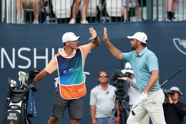 Scottie Scheffler of the United States reacts to his birdie putt on the 17th green with caddie Michael Cromie during the final round of the BMW Championship 2025 at Caves Valley Golf Club on August 17, 2025 in Owings Mills, Maryland.