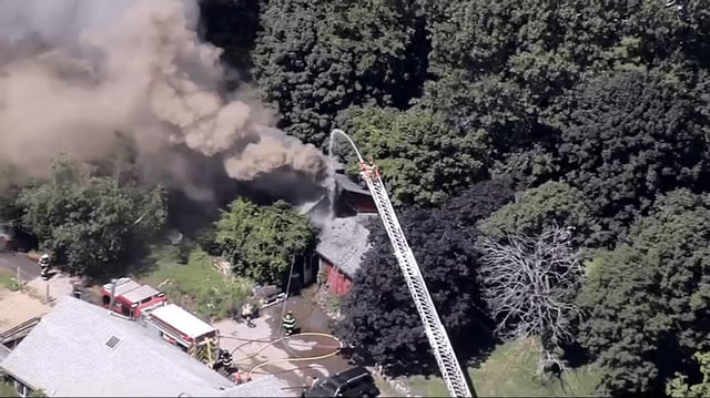 Smoke pours from a house fire in Ipswich, Massachusetts, on Monday, Aug. 18, 2025.