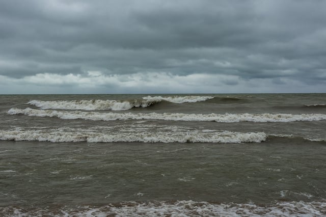 A stock photo shows large breaking waves at Lake Michigan.