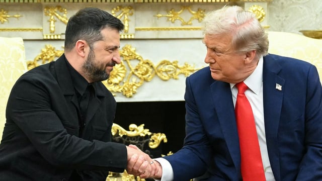 Ukrainian President Volodymyr Zelensky and US President Donald Trump shake hands during a meeting in the Oval Office of the White House in Washington, DC, on August 18, 2025.