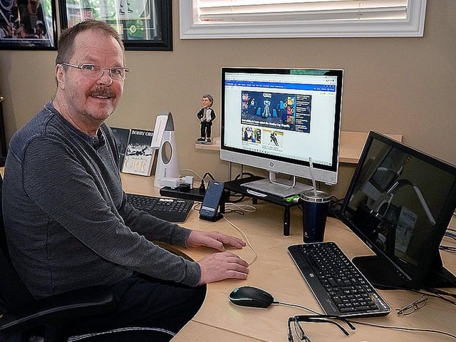 Photo of former Canuck Mark Kirton at his home in Oakville, Ontario where he still manages to manipulate a keyboard with one finger. 