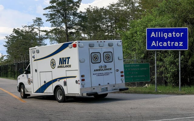 An ambulance arrives at the entrance to "Alligator Alcatraz"