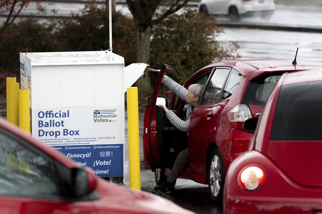 FILE - A voter drops off their ballot at a dropbox on Election Day, Nov. 5, 2024, in Portland, Ore. (AP Photo/Jenny Kane, File)