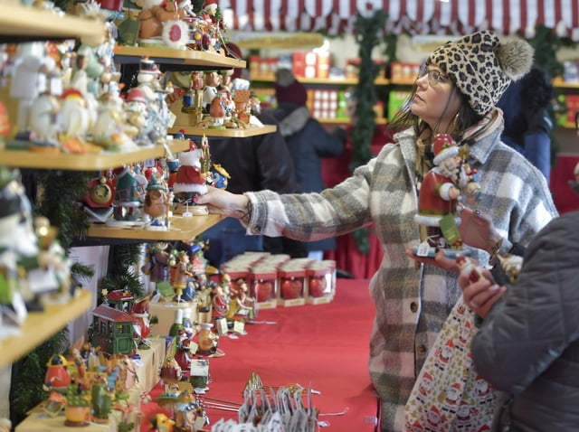 Holly Lynch of Peru shops for Christmas items at the Christkindlmarket in Aurora last year. This year&#39;s Christkindlmarket in Aurora opens on Friday at RiverEdge Park.