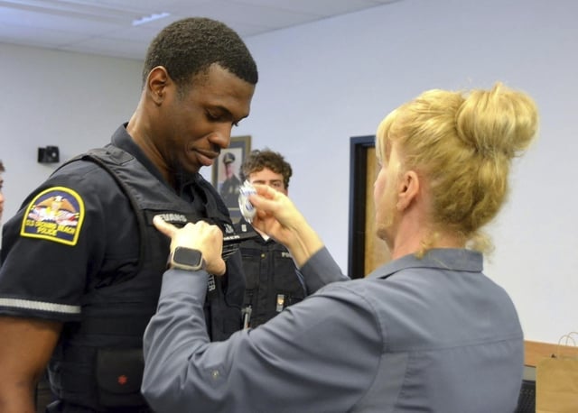 FILE - In this undated photo provided by Old Orchard Beach Police Department, Officer Jon Luke Evans receives his police badge.