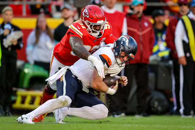Felix Anudike-Uzomah #97 of the Kansas City Chiefs sacks Bo Nix #10 of the Denver Broncos during the fourth quarter at GEHA Field at Arrowhead Stadium on November 10, 2024 in Kansas City, Missouri.